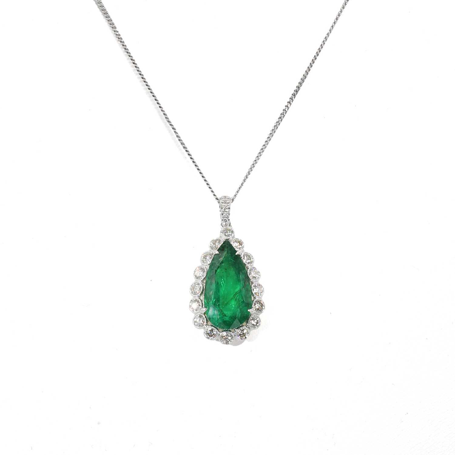 Lot 235 - An emerald and diamond drop shaped cluster pendant