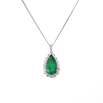 Lot 235 - An emerald and diamond drop shaped cluster pendant