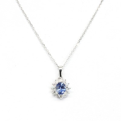 Lot 1155 - An 18ct white gold sapphire and diamond pendant and chain