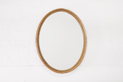 Lot 111 - A carved giltwood and gesso oval mirror