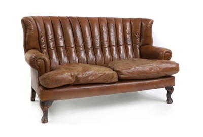 Lot 682 - A leather upholstered sofa