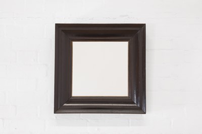 Lot 431 - An ebonised pearwood mirror