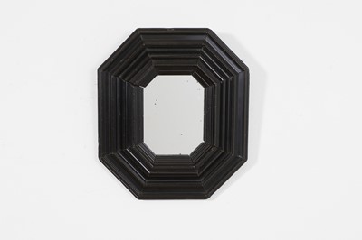 Lot 221 - A small ebonised octagonal mirror