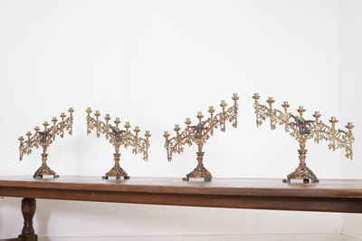 Lot 300 - A set of four Gothic Revival gilt-brass and painted altar candelabra