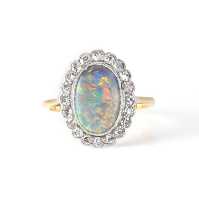 Lot 1068 - A black opal and diamond cluster ring