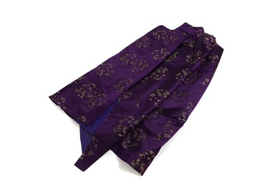 Lot 551 - A Tibetan dark purple and gold brocade silk chuba