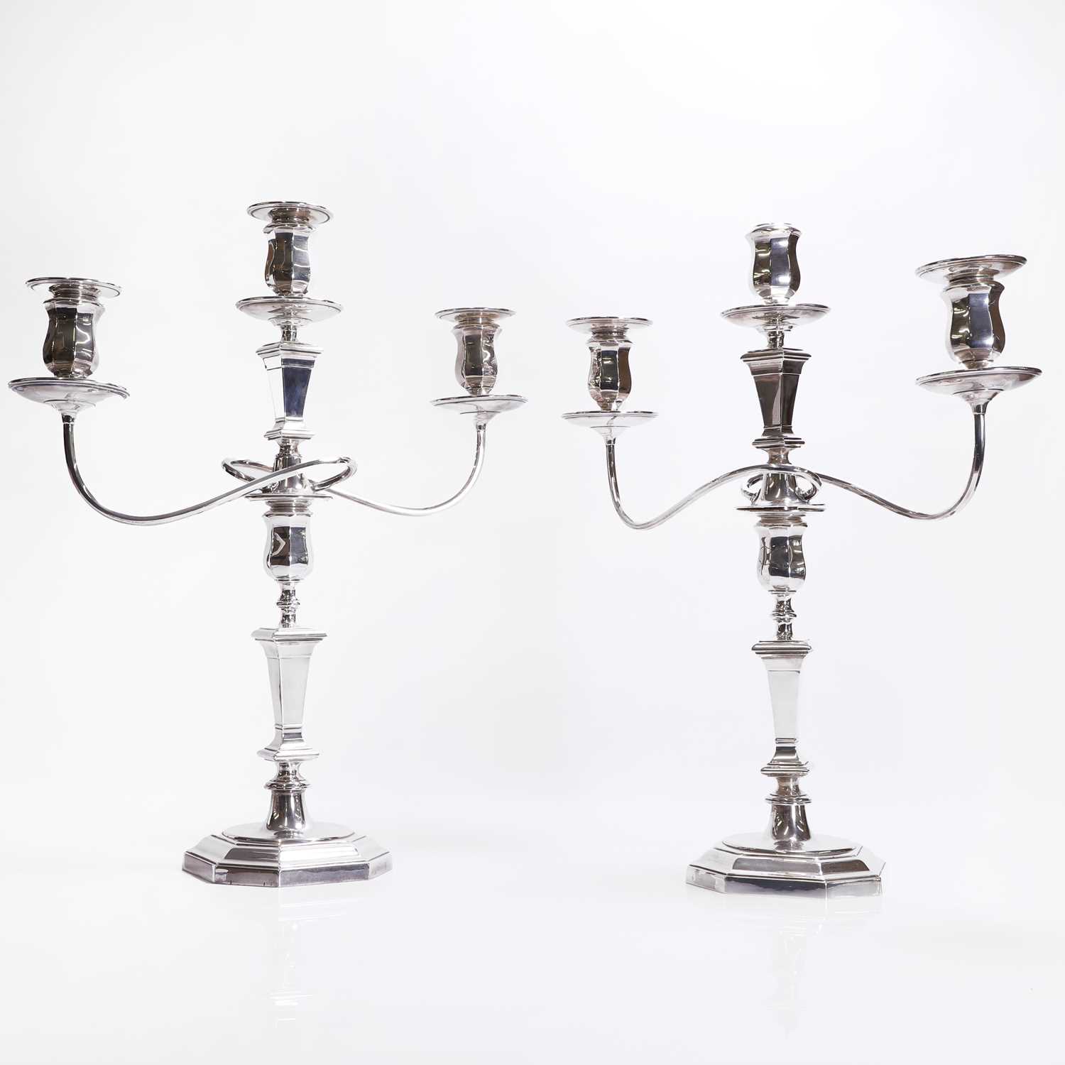 Lot 94 - A pair of silver three-branch candelabra