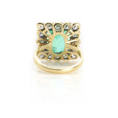 Lot 238 - An 18ct gold Colombian emerald and diamond cluster ring