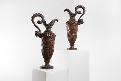 Lot 403 - A pair of carved fruitwood ewers