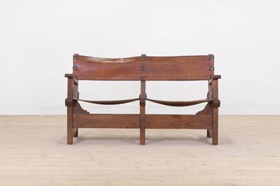 Lot 122 - An oak and leather settee