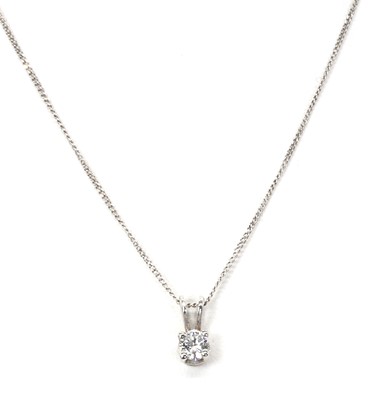 Lot 1101 - A solitaire diamond pendant and chain