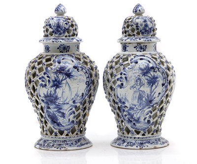 Lot 146 - A pair of Delft pottery vases and covers