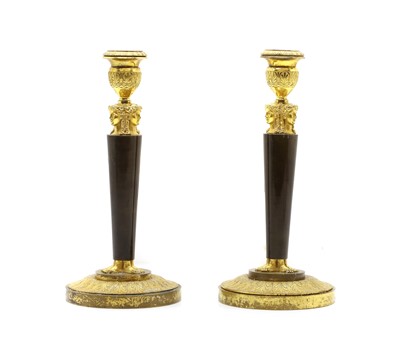 Lot 317 - A pair of Continental Empire style gilt brass candlesticks