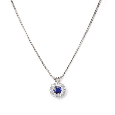 Lot 1156 - A sapphire and diamond cluster pendant