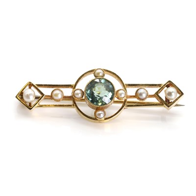 Lot 1051 - An Edwardian tourmaline and split pearl brooch