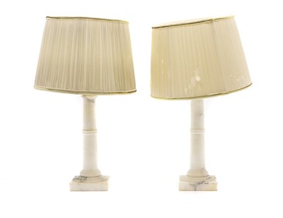 Lot 615 - A pair of alabaster columnar table lamps