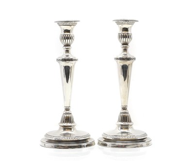 Lot 4 - A pair of Edwardian silver candlesticks