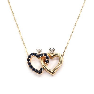 Lot 1148 - A sapphire, ruby and diamond double heart necklace