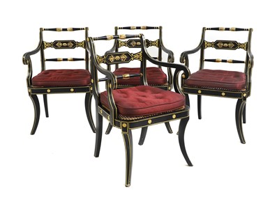 Lot 644 - A set of four ebonised and parcel gilt elbow chairs