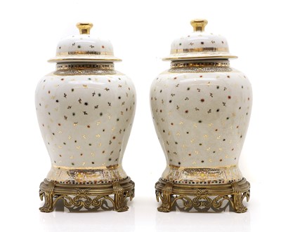 Lot 302 - A pair of temple vases and covers