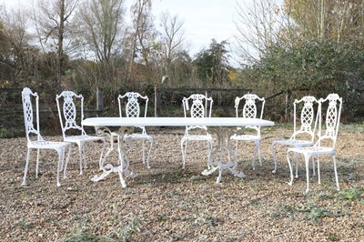 Lot 775 - A white painted cast iron dining suite