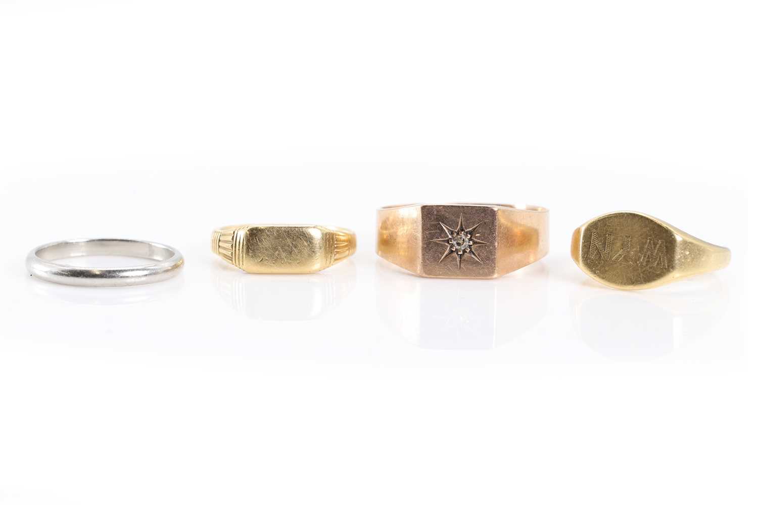 Lot 1331 - A group of three gold rings and a platinum ring