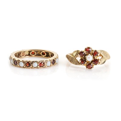 Lot 1306 - A 9ct gold opal and garnet eternity ring and a 9ct gold seed pearl and garnet cluster ring