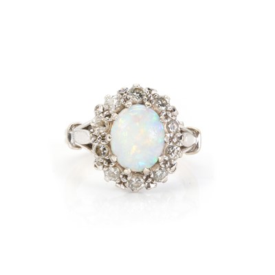 Lot 1228 - A white gold opal and diamond cluster ring