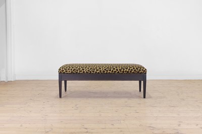 Lot An imitation leopard-skin and ebonised wooden ottoman