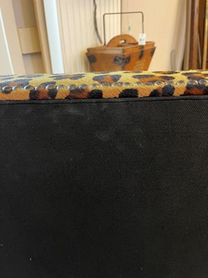 Lot 633 - An imitation leopard-skin and ebonised wooden ottoman