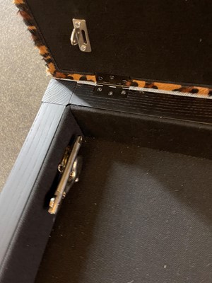 Lot 633 - An imitation leopard-skin and ebonised wooden ottoman