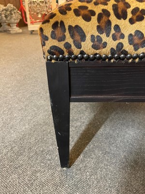 Lot 633 - An imitation leopard-skin and ebonised wooden ottoman