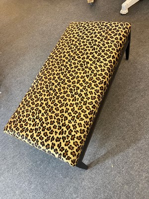 Lot 633 - An imitation leopard-skin and ebonised wooden ottoman