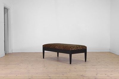 Lot 633 - An imitation leopard-skin and ebonised wooden ottoman