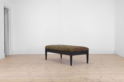 Lot 633 - An imitation leopard-skin and ebonised wooden ottoman