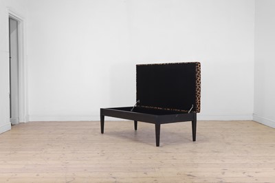 Lot 633 - An imitation leopard-skin and ebonised wooden ottoman