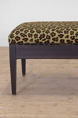 Lot 633 - An imitation leopard-skin and ebonised wooden ottoman