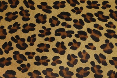Lot 633 - An imitation leopard-skin and ebonised wooden ottoman