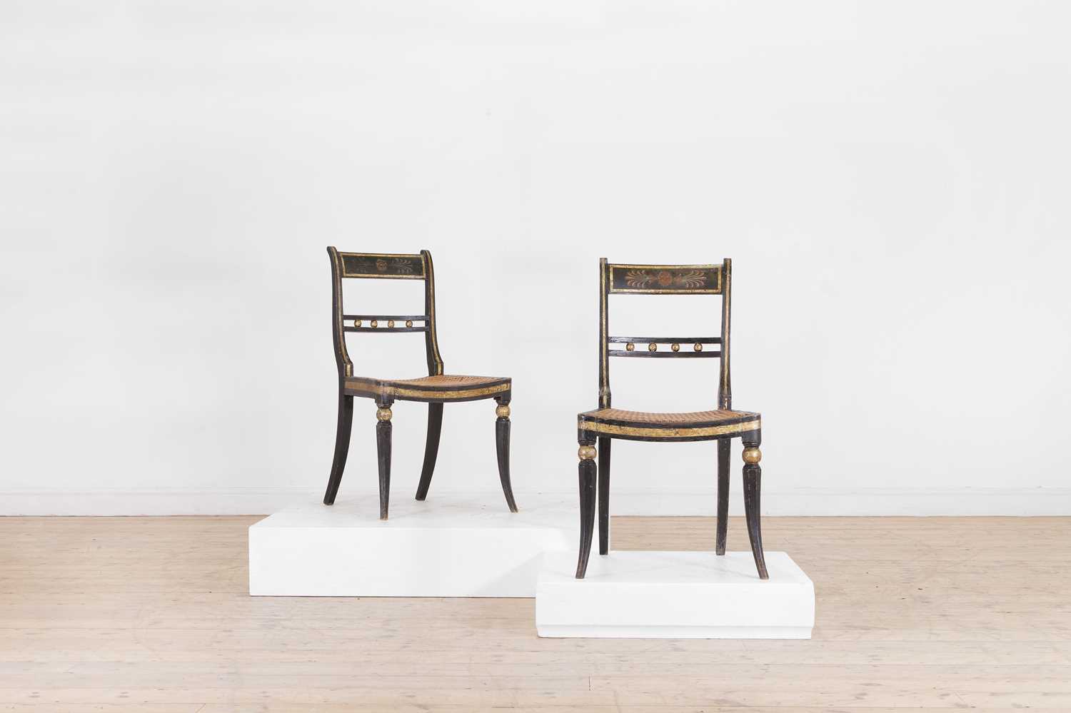 Lot 642 - A pair of Regency ebonised wooden side chairs