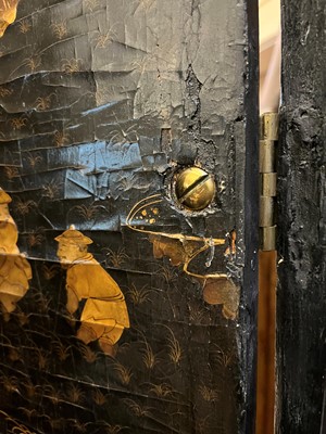 Lot 643 - A black and gilt lacquer folding screen
