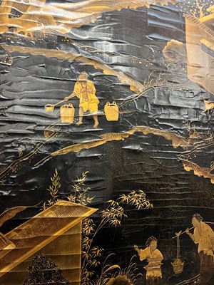 Lot 643 - A black and gilt lacquer folding screen