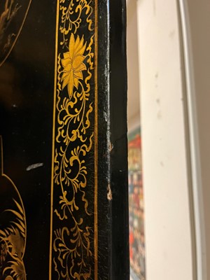 Lot 643 - A black and gilt lacquer folding screen
