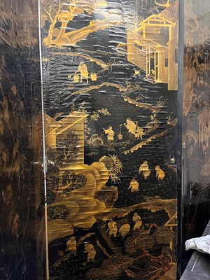 Lot 643 - A black and gilt lacquer folding screen