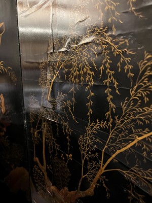Lot 643 - A black and gilt lacquer folding screen