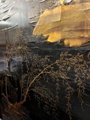 Lot 643 - A black and gilt lacquer folding screen