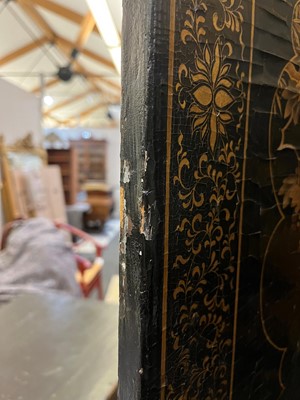 Lot 643 - A black and gilt lacquer folding screen