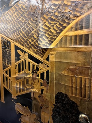 Lot 643 - A black and gilt lacquer folding screen