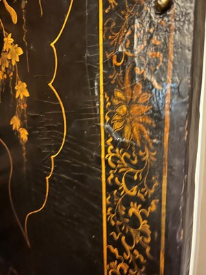 Lot 643 - A black and gilt lacquer folding screen