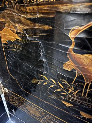 Lot 643 - A black and gilt lacquer folding screen