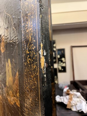 Lot 643 - A black and gilt lacquer folding screen